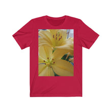 Load image into Gallery viewer, Close up photograph of two yellow lily's printed onto a red T-Shirt.