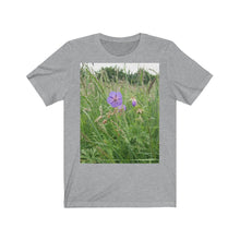 Load image into Gallery viewer, Photograph of a meadow cranesbill flower printed onto a grey (athletic heather) T-Shirt.