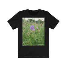 Load image into Gallery viewer, Photograph of a meadow cranesbill flower printed onto a black T-Shirt.