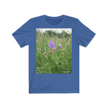 Load image into Gallery viewer, Photograph of a meadow cranesbill flower printed onto a true royal blue T-Shirt.
