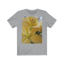 Load image into Gallery viewer, Close up photograph of two yellow lily's printed onto a grey (athletic heather)T-Shirt.

